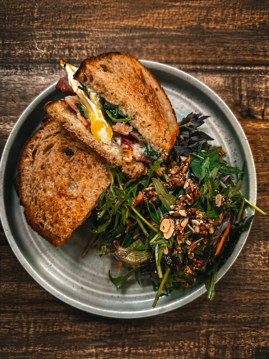 Toasted sandwich with egg and greens at Hey Jude Cafe