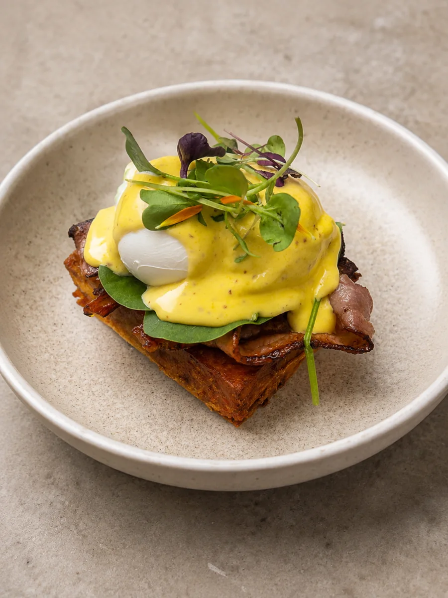 Poached eggs, bacon and toast served at Hey Jude Cafe