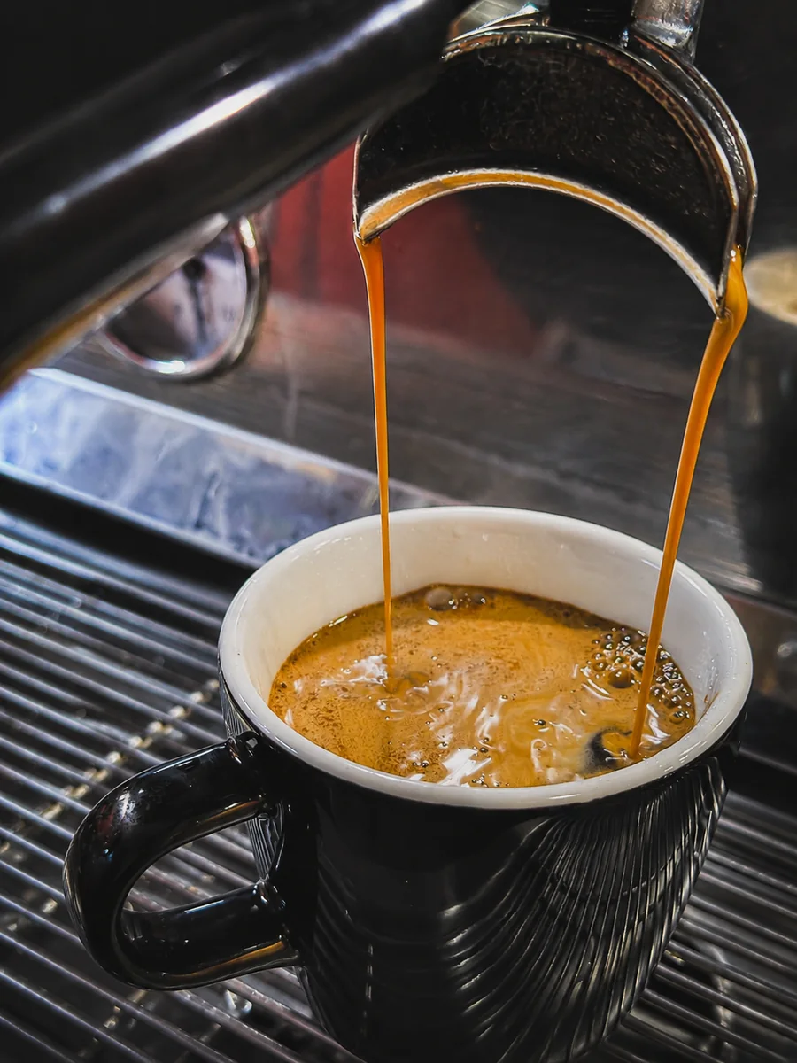 Coffee pouring from the espresso machine at Hey Jude Cafe